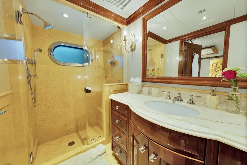 Silver Lining Yacht Photos Pics Luxurious bathroom on 2016 Christensen Tri-Deck yacht with elegant wood and marble finishes.