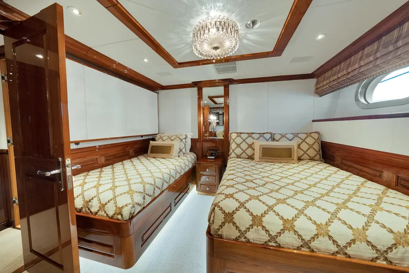 Silver Lining Yacht Photos Pics Luxurious twin bedroom on 2016 Christensen Tri-Deck yacht with elegant wood finishes.