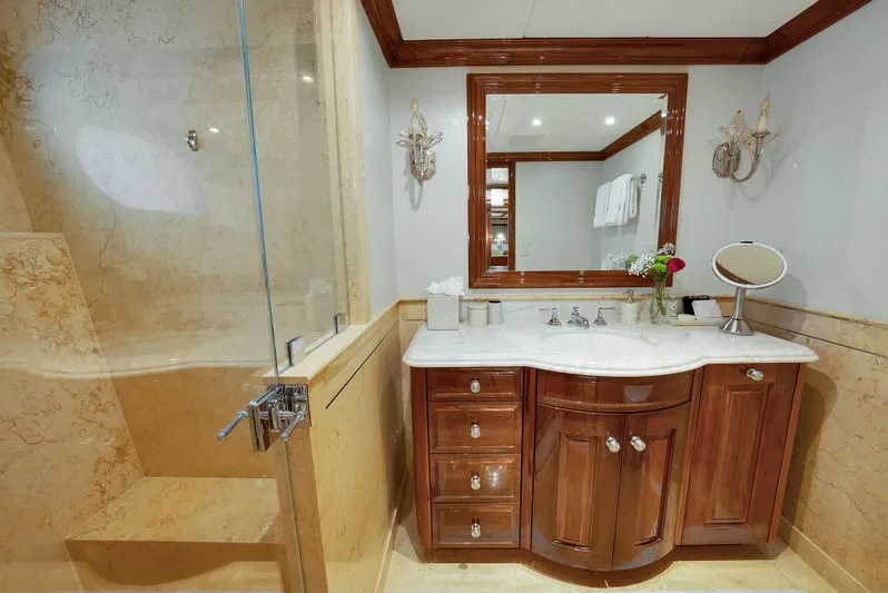 Silver Lining Yacht Photos Pics Luxurious bathroom on 2016 Christensen Tri-Deck yacht with elegant wood cabinetry and marble accents.