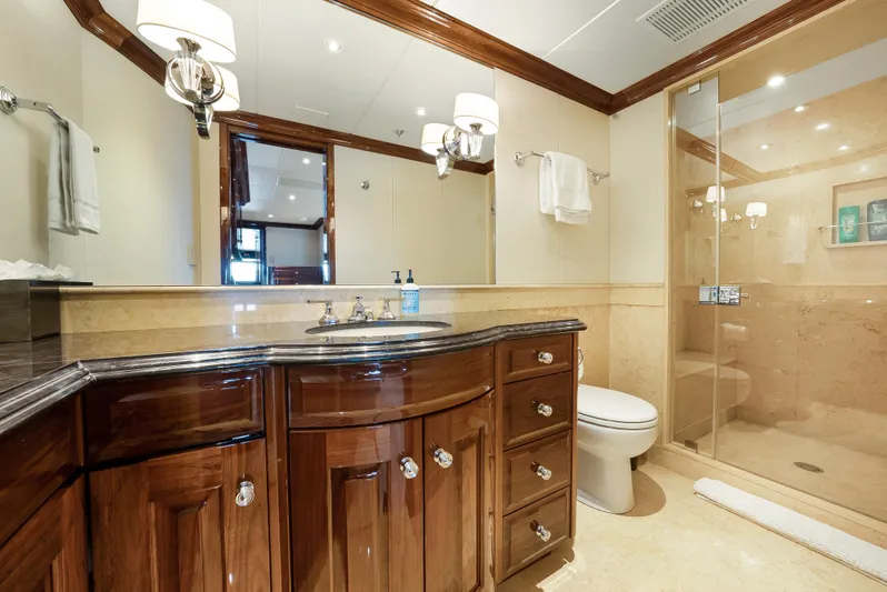 Silver Lining Yacht Photos Pics Luxurious yacht bathroom with wooden cabinetry, glass shower, and elegant lighting on a 2016 Christensen Tri-Deck.