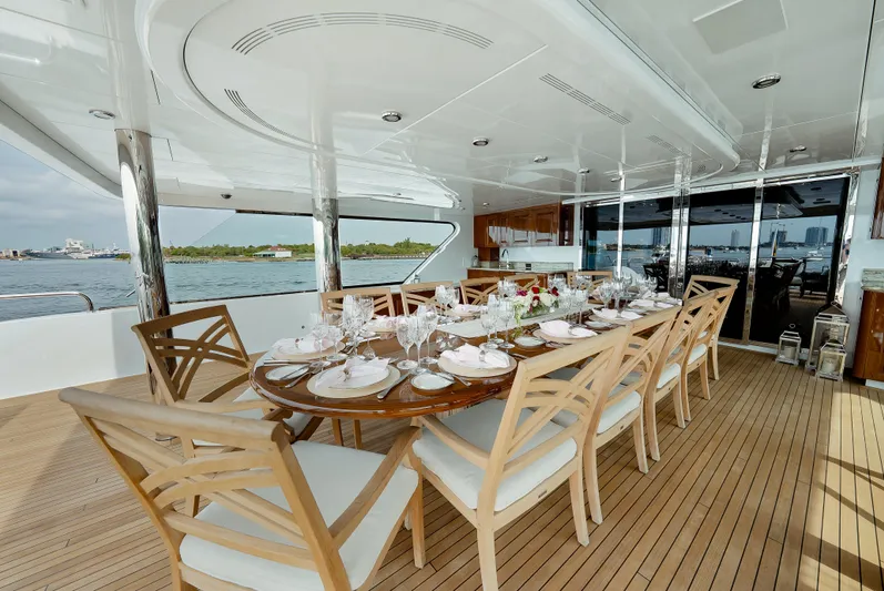 Silver Lining Yacht Photos Pics Luxurious dining area on 2016 Christensen Tri-Deck yacht with elegant table setting.