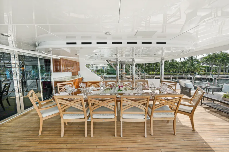 Silver Lining Yacht Photos Pics Luxurious outdoor dining area on 2016 Christensen Tri-Deck yacht with elegant wooden furniture.