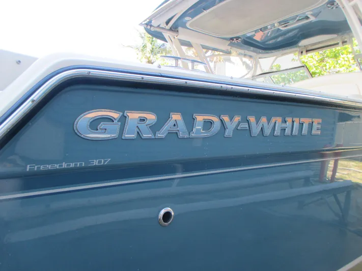 Yacht Photos Pics 2018 Grady-White Freedom 307 boat, blue exterior with logo and model name.