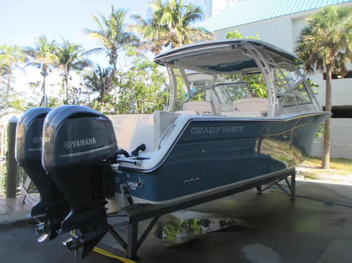  Yacht Photos Pics 2018 Grady-White Freedom 307 boat with Yamaha engines, docked near palm trees.