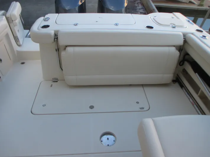 Yacht Photos Pics 2018 Grady-White Freedom 307 boat interior with cushioned seating and storage compartments.