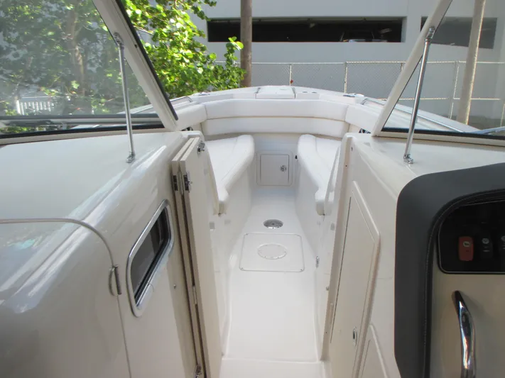  Yacht Photos Pics 2018 Grady-White Freedom 307 boat interior with white seating and sleek design.