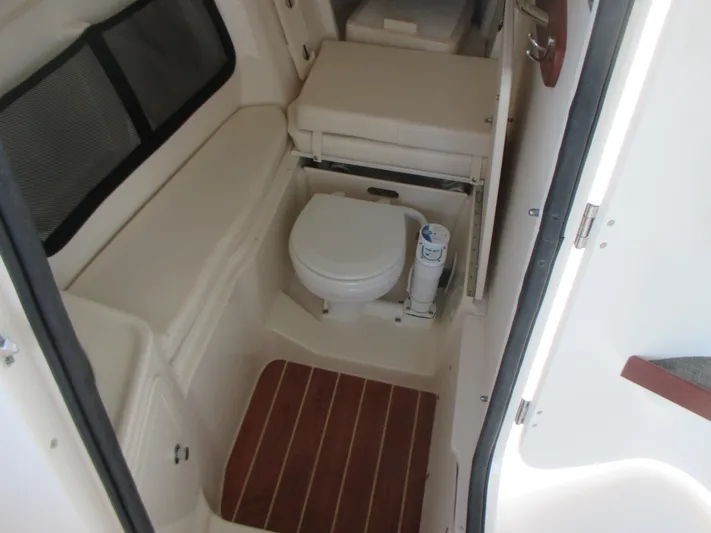  Yacht Photos Pics 2018 Grady-White Freedom 307 boat interior with compact marine toilet.