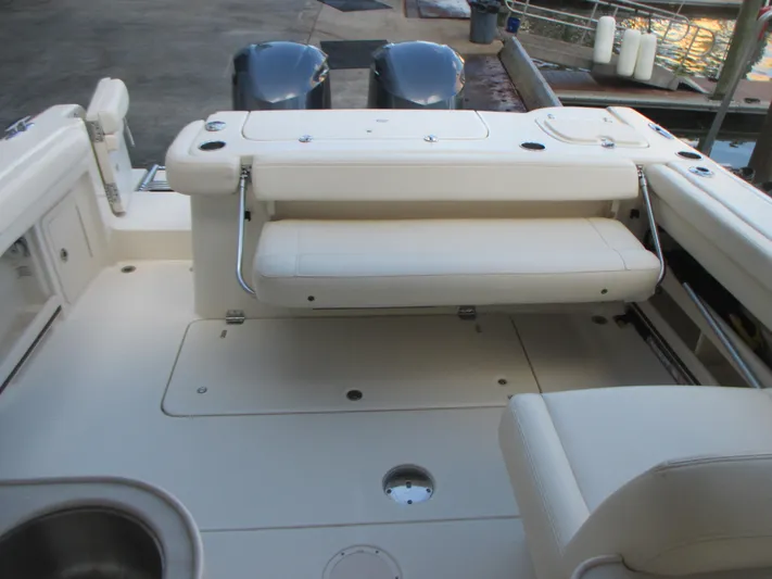  Yacht Photos Pics 2018 Grady-White Freedom 307 boat interior with seating and dual engines at dock.