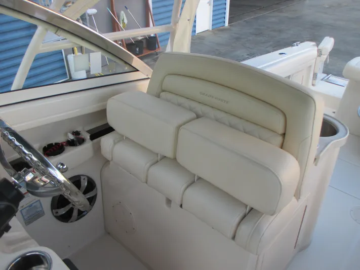  Yacht Photos Pics 2018 Grady-White Freedom 307 boat interior with beige seating and steering wheel.
