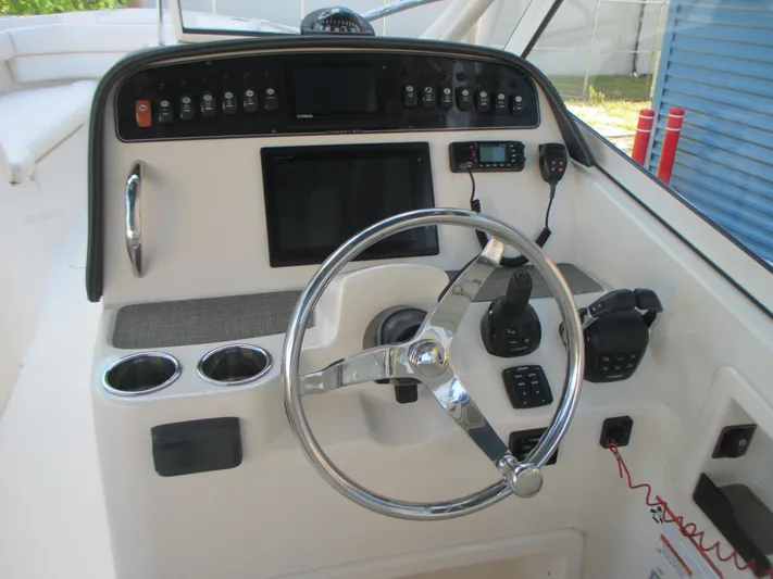  Yacht Photos Pics 2018 Grady-White Freedom 307 boat dashboard with steering wheel and control panel.