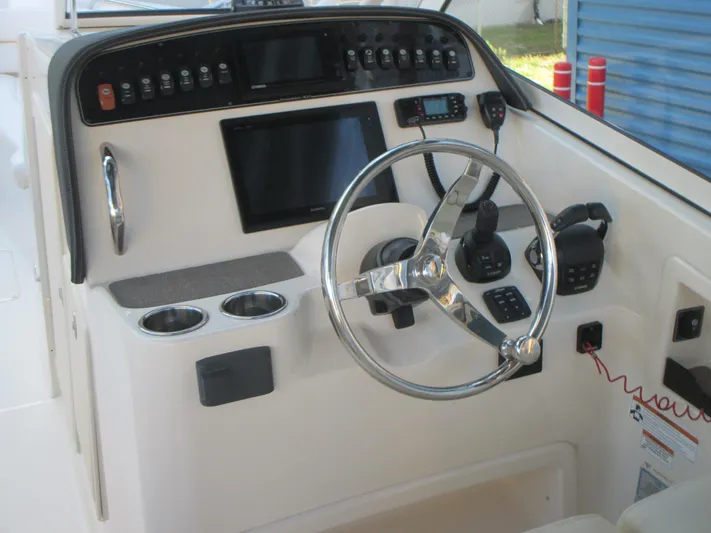  Yacht Photos Pics 2018 Grady-White Freedom 307 boat dashboard with steering wheel and control panel.