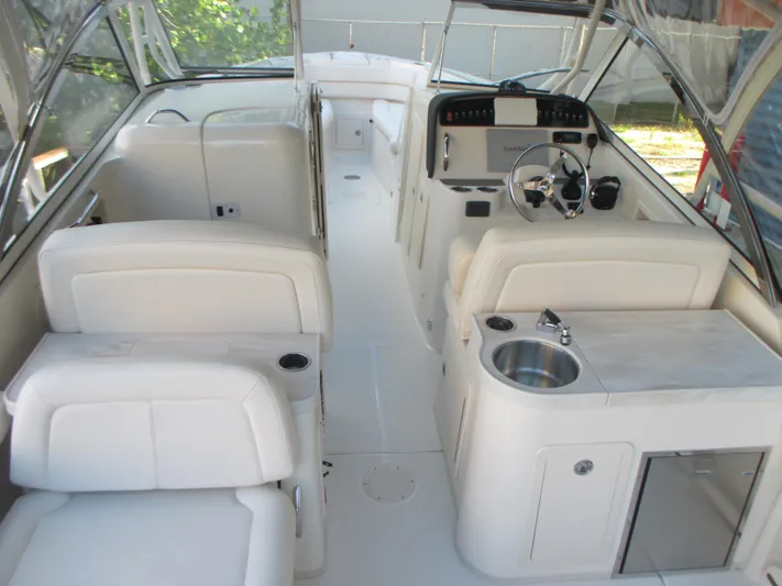  Yacht Photos Pics 2018 Grady-White Freedom 307 boat interior with seating, steering wheel, and sink.