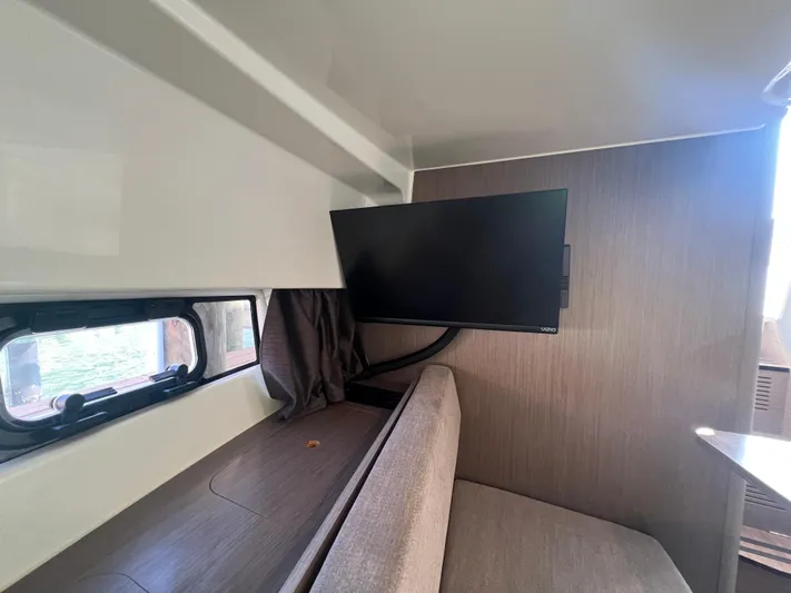  Yacht Photos Pics 2024 Beneteau 29' Flyer 9 SUNdeck interior with TV and seating area.