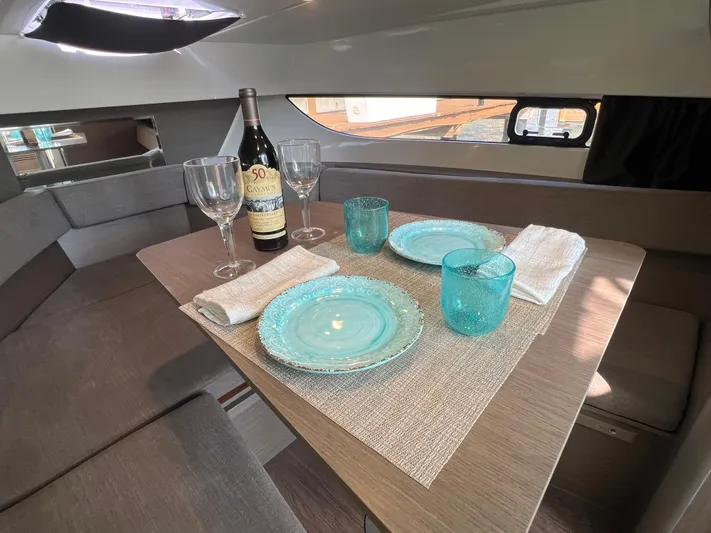  Yacht Photos Pics 2024 Beneteau Flyer 9 SUNdeck cabin dining area with elegant table setting.