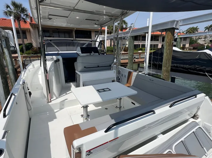  Yacht Photos Pics 2024 Beneteau 29' Flyer 9 SUNdeck boat with spacious seating and table, docked at marina.