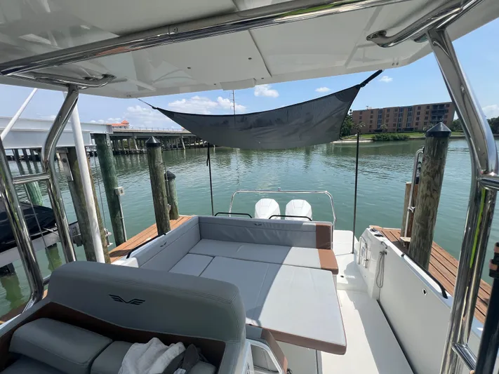  Yacht Photos Pics 2024 Beneteau 29' Flyer 9 SUNdeck, spacious deck with seating, docked by calm waters.