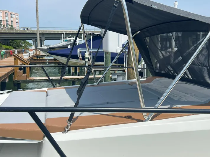  Yacht Photos Pics 2024 Beneteau 29' Flyer 9 SUNdeck moored at a marina, featuring a sleek design and sunshade.