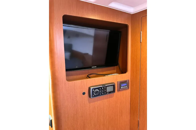 Dark Star Yacht Photos Pics Interior of 2016 Beneteau Swift Trawler 34 with TV and control panel.
