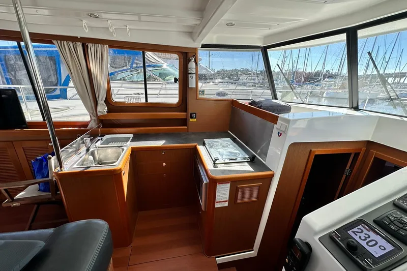 Dark Star Yacht Photos Pics Interior of 2016 Beneteau Swift Trawler 34 with kitchen and navigation area.