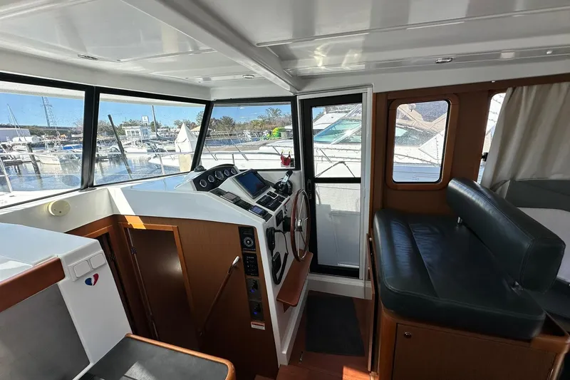Dark Star Yacht Photos Pics Interior of 2016 Beneteau Swift Trawler 34, featuring helm and seating area.