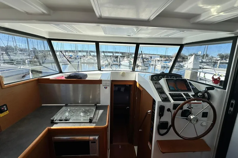 Dark Star Yacht Photos Pics 2016 Beneteau Swift Trawler 34 interior with helm, navigation equipment, and galley.
