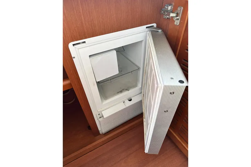 Dark Star Yacht Photos Pics Open refrigerator in 2016 Beneteau Swift Trawler 34, showcasing interior storage space.