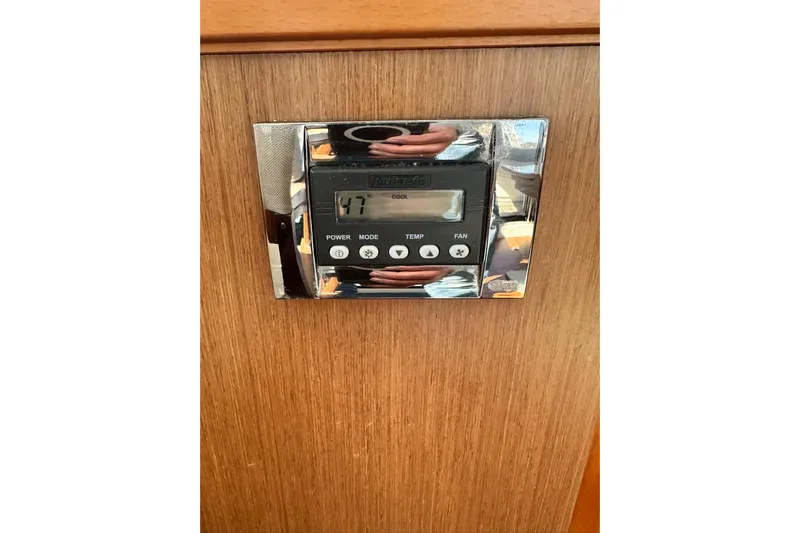 Dark Star Yacht Photos Pics Thermostat control panel on 2016 Beneteau Swift Trawler 34, mounted on wooden surface.