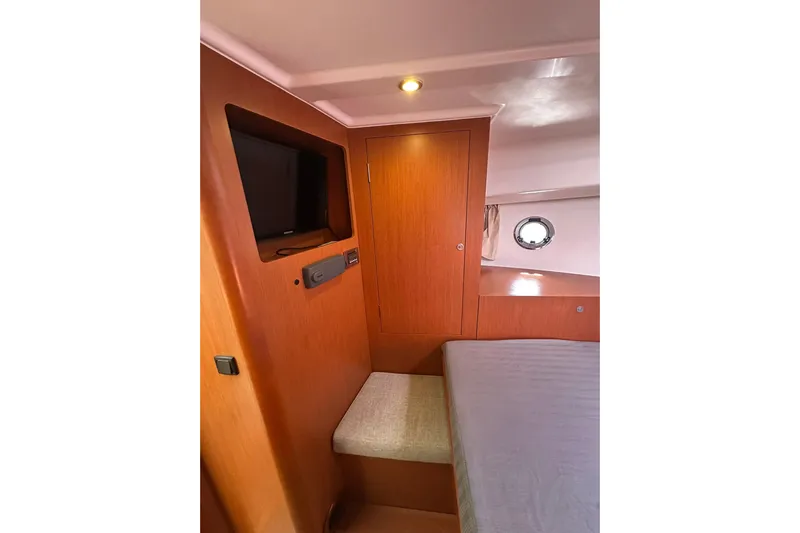 Dark Star Yacht Photos Pics Interior cabin of 2016 Beneteau Swift Trawler 34 with TV and wooden finish.