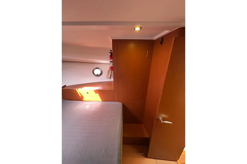 Dark Star Yacht Photos Pics Interior cabin of 2016 Beneteau Swift Trawler 34 with wooden finish and porthole.