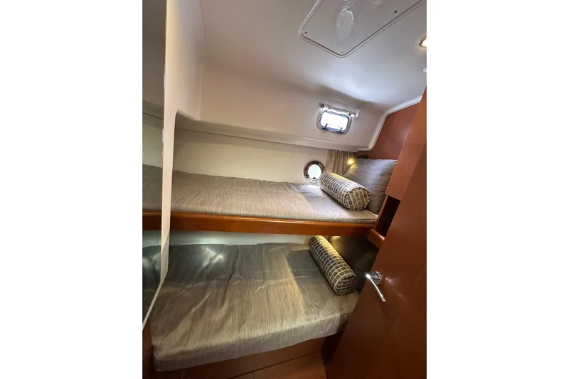 Dark Star Yacht Photos Pics 2016 Beneteau Swift Trawler 34 cabin with bunk beds and porthole window.