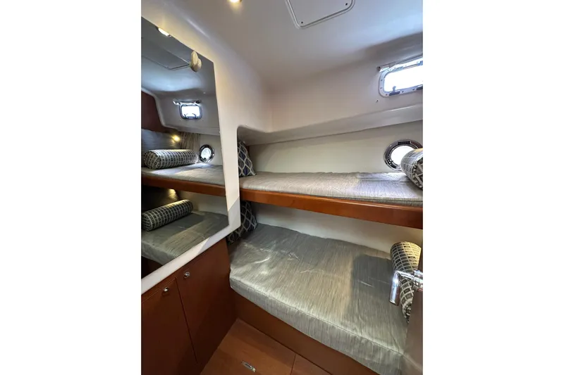 Dark Star Yacht Photos Pics 2016 Beneteau Swift Trawler 34 cabin with bunk beds and porthole windows.