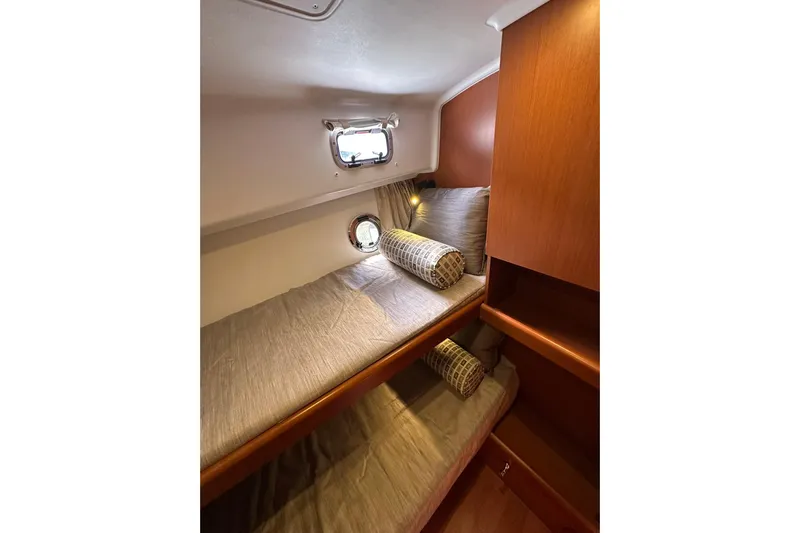 Dark Star Yacht Photos Pics Cozy cabin interior of 2016 Beneteau Swift Trawler 34 with twin beds and porthole.
