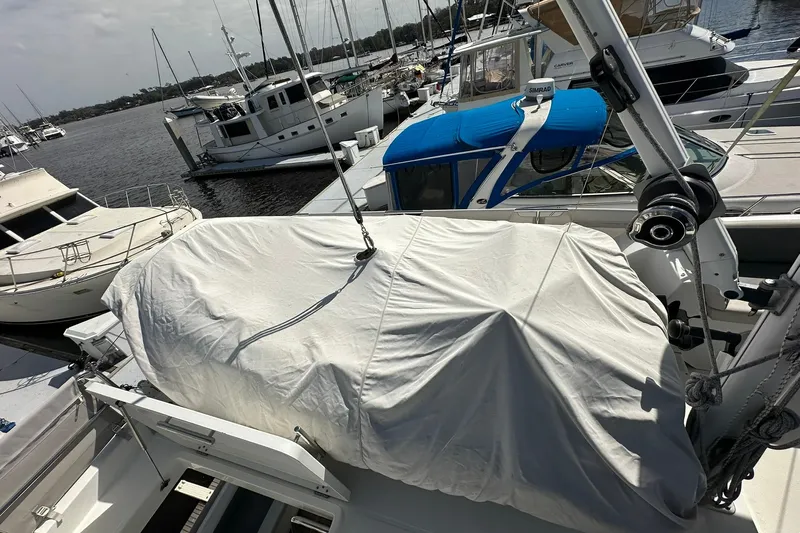 Dark Star Yacht Photos Pics 2016 Beneteau Swift Trawler 34 docked, covered, with other boats in marina background.