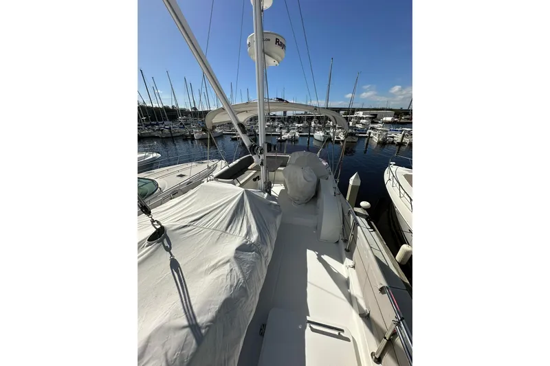Dark Star Yacht Photos Pics 2016 Beneteau Swift Trawler 34 docked at marina, covered deck, clear sky.