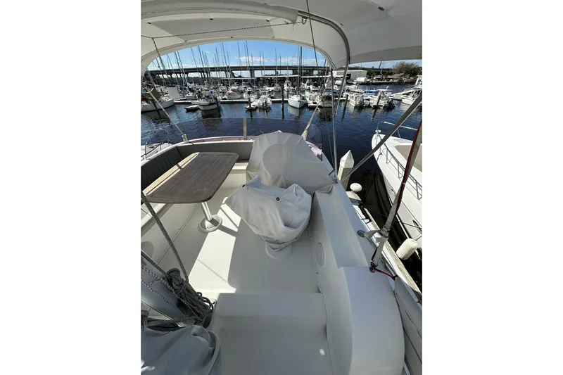 Dark Star Yacht Photos Pics 2016 Beneteau Swift Trawler 34 flybridge with seating, table, and marina view.