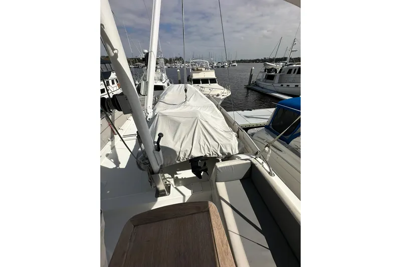 Dark Star Yacht Photos Pics 2016 Beneteau Swift Trawler 34 docked, featuring covered equipment and seating area.