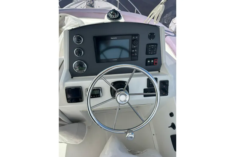 Dark Star Yacht Photos Pics 2016 Beneteau Swift Trawler 34 helm with steering wheel and navigation controls.