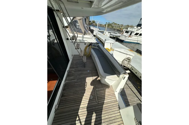 Dark Star Yacht Photos Pics 2016 Beneteau Swift Trawler 34 deck with seating, docked at marina.