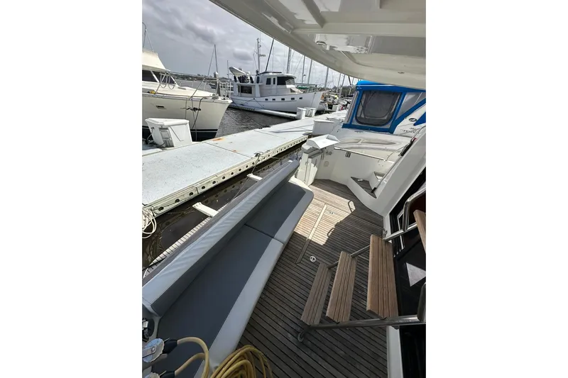 Dark Star Yacht Photos Pics 2016 Beneteau Swift Trawler 34 docked, showcasing deck and seating area.