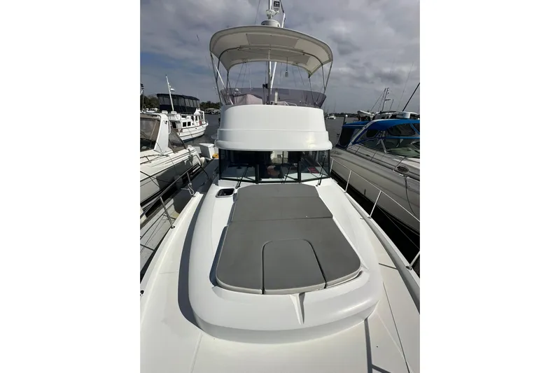 Dark Star Yacht Photos Pics 2016 Beneteau Swift Trawler 34 docked, showcasing spacious deck and flybridge.