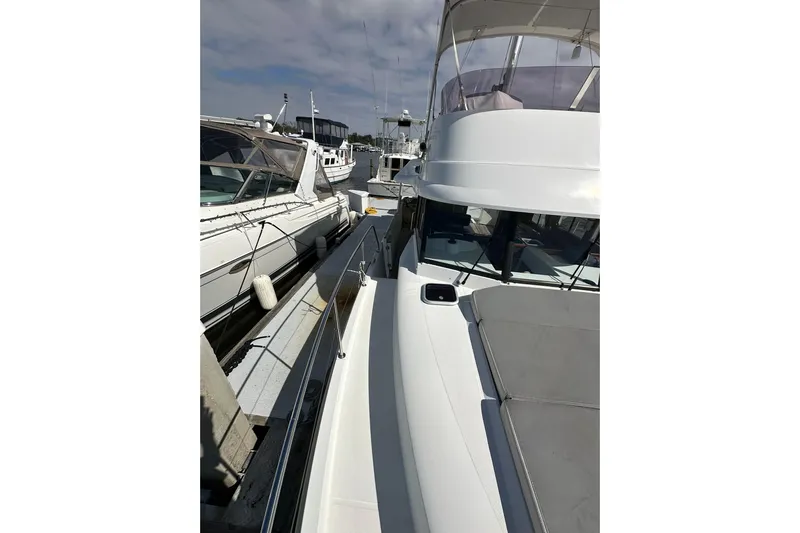 Dark Star Yacht Photos Pics 2016 Beneteau Swift Trawler 34 docked at marina, side view.