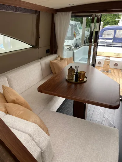  Yacht Photos Pics Luxurious interior of 2023 Van der Heijden Exclusive Deluxe 1700 yacht with elegant seating and table.