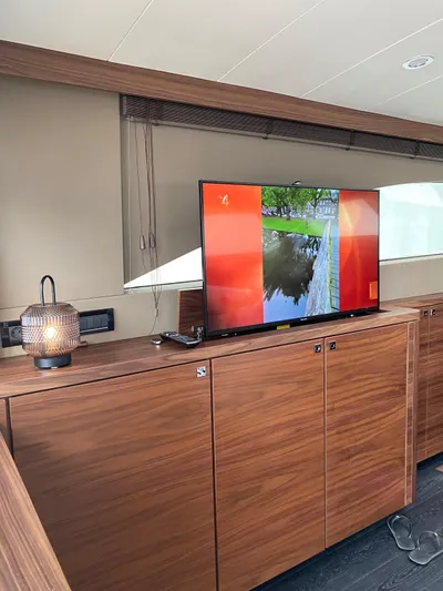 Yacht Photos Pics Luxurious interior of 2023 Van der Heijden Exclusive Deluxe 1700 yacht with TV and wooden cabinetry.