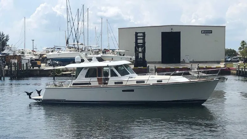 Happy Days Yacht Photos Pics 2016 Sabre 48 Salon Express yacht docked at a marina with boats in the background.