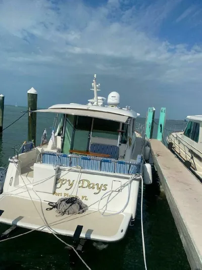 Happy Days Yacht Photos Pics 2016 Sabre 48 Salon Express yacht docked at marina under cloudy sky.