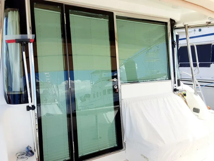 Happy Days Yacht Photos Pics 2016 Sabre 48 Salon Express yacht with glass sliding doors and covered seating area.