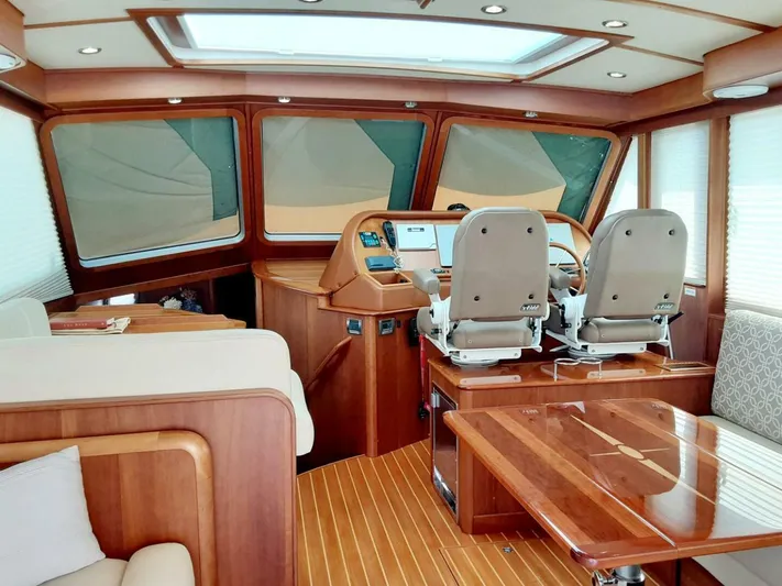 Happy Days Yacht Photos Pics Interior of 2016 Sabre 48 Salon Express yacht with wooden finishes and helm station.
