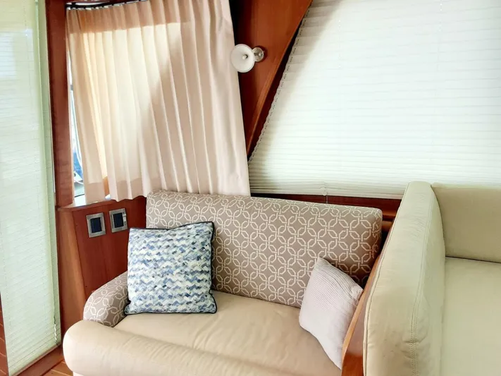 Happy Days Yacht Photos Pics Interior of 2016 Sabre 48 Salon Express with elegant seating and decorative pillows.