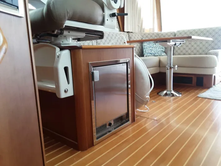 Happy Days Yacht Photos Pics Interior of 2016 Sabre 48 Salon Express with wood flooring and seating area.
