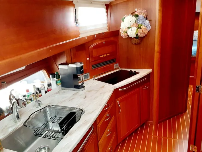 Happy Days Yacht Photos Pics 2016 Sabre 48 Salon Express kitchen with marble countertop, sink, and coffee maker.